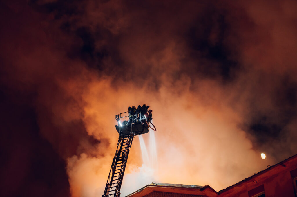 Firefighter operating on a crane during emergency response
